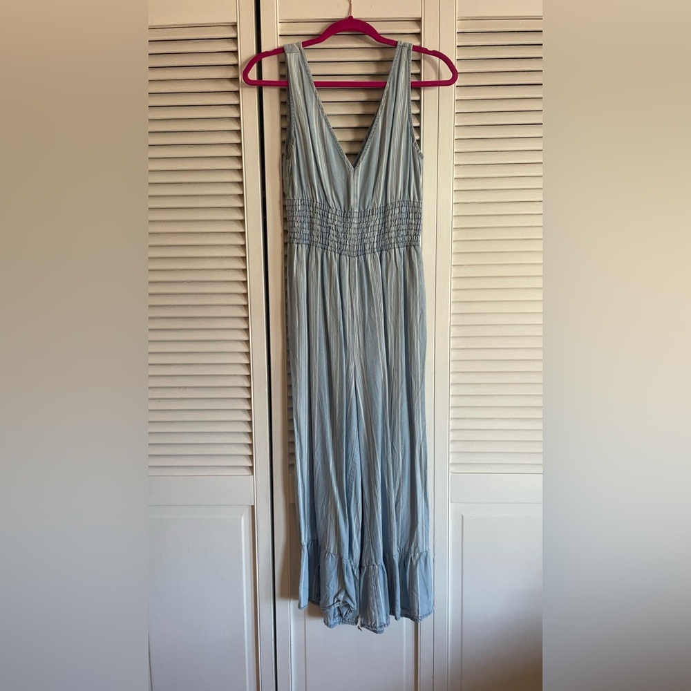 Blue jumpsuit with ruffles and white stripes